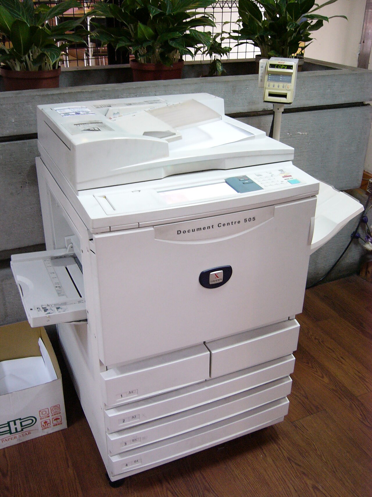 Floor-standing copier in an institutional hallway